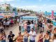 Thousands of festival guests sampling fresh seafood dishes from pop-up restaurant booths along the sandy shores of Lummus Park at the South Beach Seafood Festival 2026 in Miami Beach