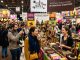 Visitors exploring chocolate stalls at Salon du Chocolat 2026 in Paris, surrounded by colorful displays of artisan chocolate