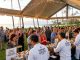 World-class chefs serving locally sourced Hawaiian dishes to guests at an oceanfront grand tasting event during the Hawaii Food and Wine Festival 2026 at Sheraton Maui Resort in Kaananapali